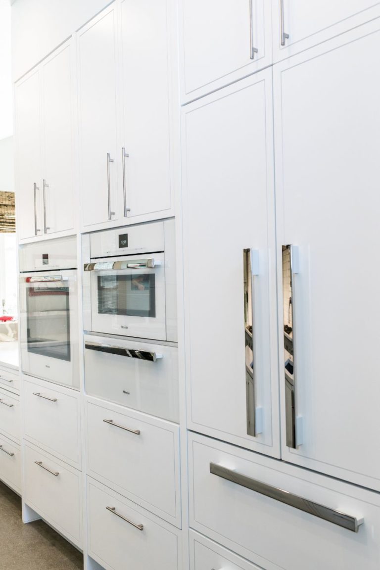 modern Austin kitchen remodel with all white cabinets and appliances and metal accents.