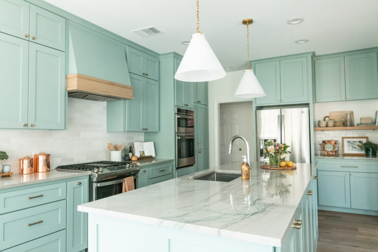 Remodeled Kitchen with Pale Blue Cabinets and Grey Quartz Countertops