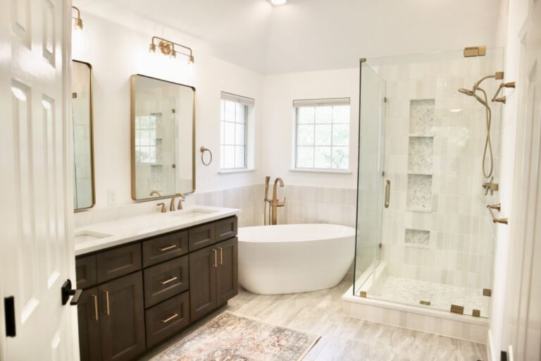 Modern bathroom remodel with freestanding tub, glass shower, and double vanity by Austin area home remodeling contractors, Wild Creek Custom Renovations.